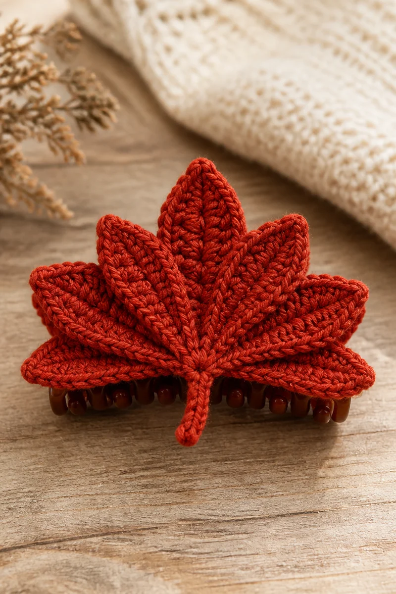 Crochet maple leaf hair claw clip adorned with vibrant autumn colors.