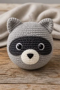 Crochet raccoon baby stuffed toy, handmade and perfect for children.